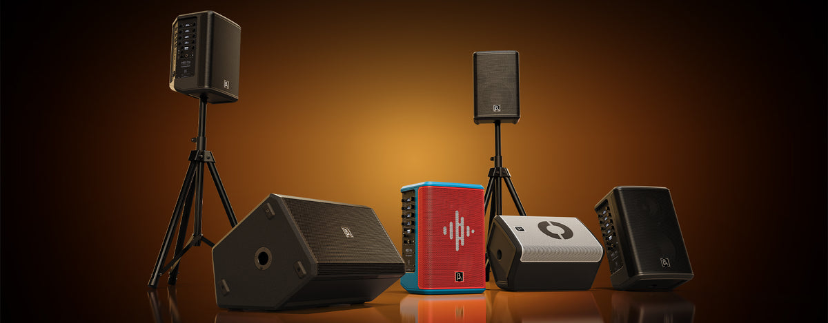 Collection of speakers and audio equipment on a brown background
