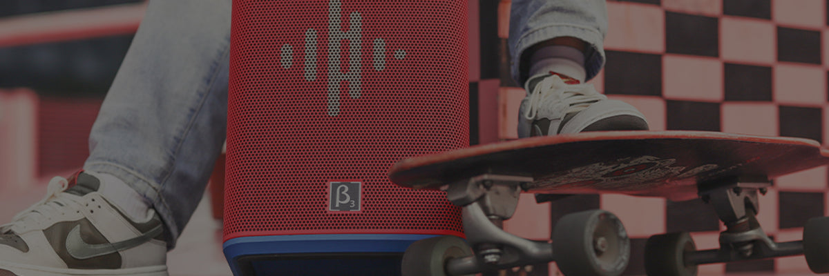 Person riding a skateboard with a red speaker in the background