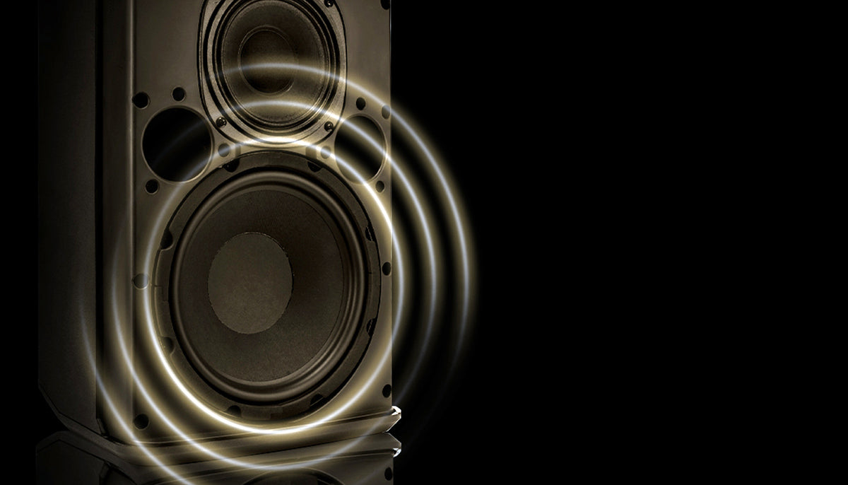 Speaker with glowing circular design on a black background